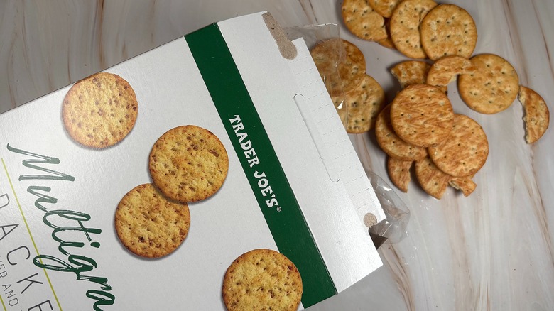 Trader Joe's Multigrain Crackers and box on marbled surface