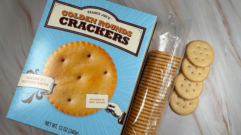 Trader Joe's Golden Rounds Crackers and box on marbled surface