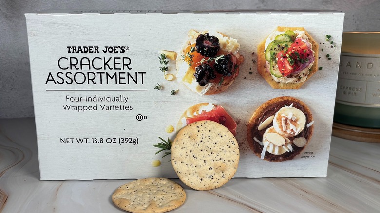 Two crackers in front of box on table