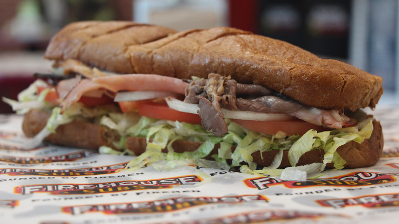 A large submarine from Firehouse Subs on branded paper