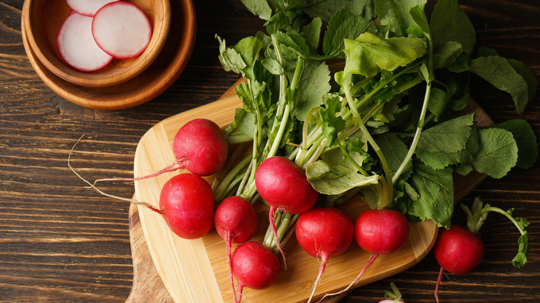 radishes with tops on cutting board