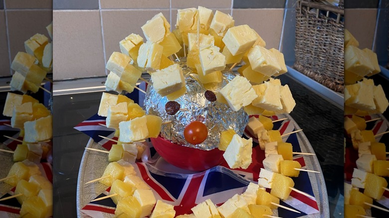 A hedgehog made from cheese and pineapple skewers on British flags