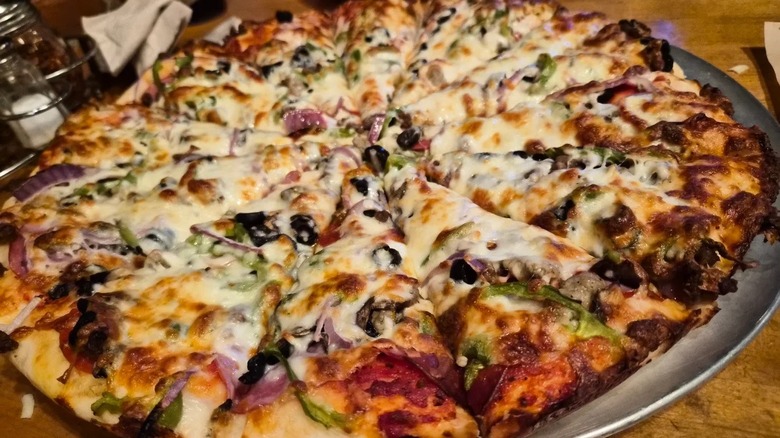 A vegetable pizza on a metal pan