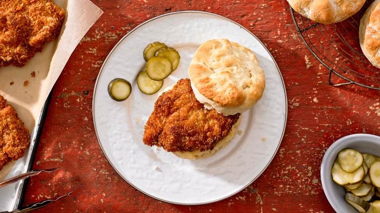 A fried chicken biscuit sandwich on a plate