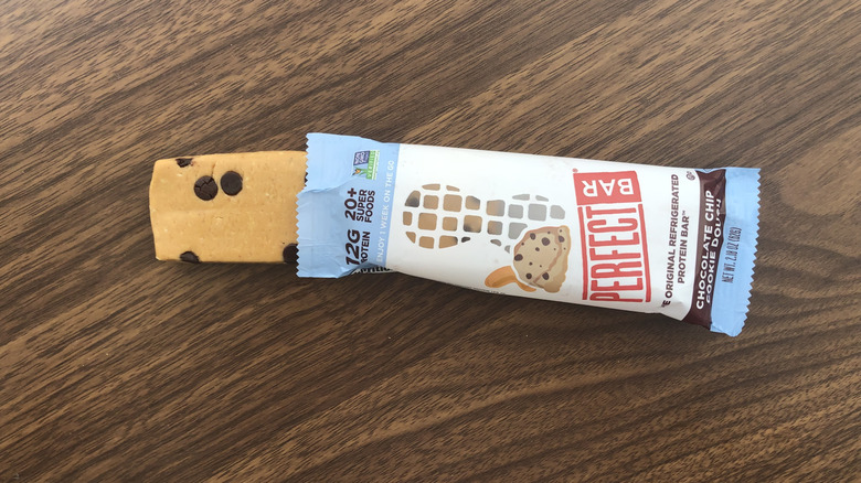 A Perfect Chocolate Chip Cookie Dough protein bar sticking out of its packaging