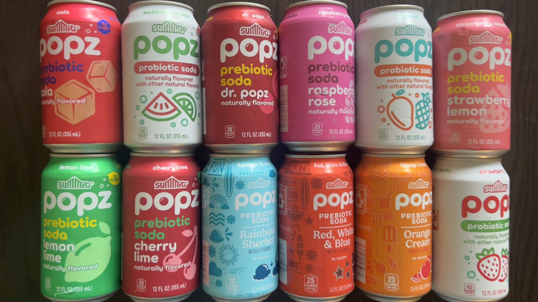 12 different cans of Aldi Summit Popz soda.