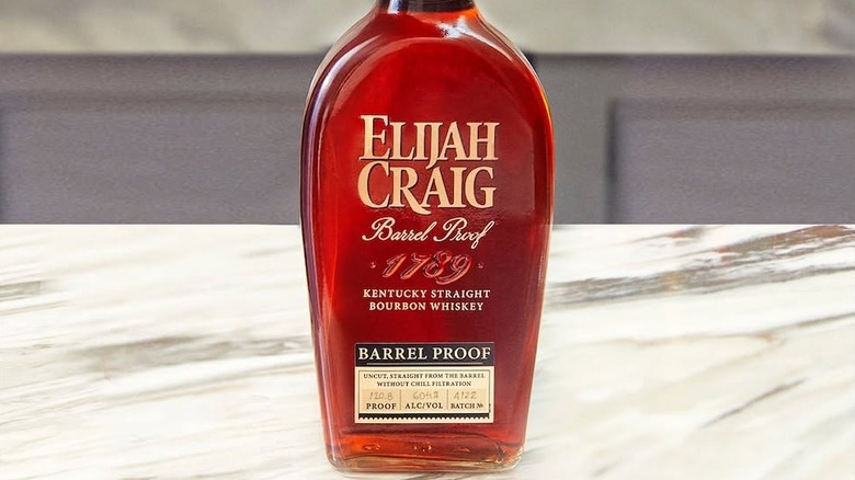 A close up of a bottle of Elijah Craig Barrel Proof placed on a marble countertop