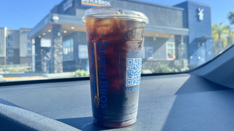 Dutch Bros Banana Bread Cold Brew with view of store
