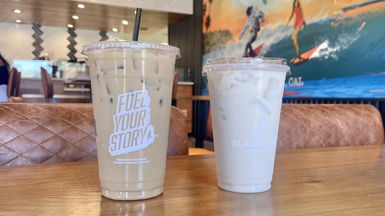 Drinks from Black Rock Coffee Bar on a table served in plastic cups inside the coffee shop