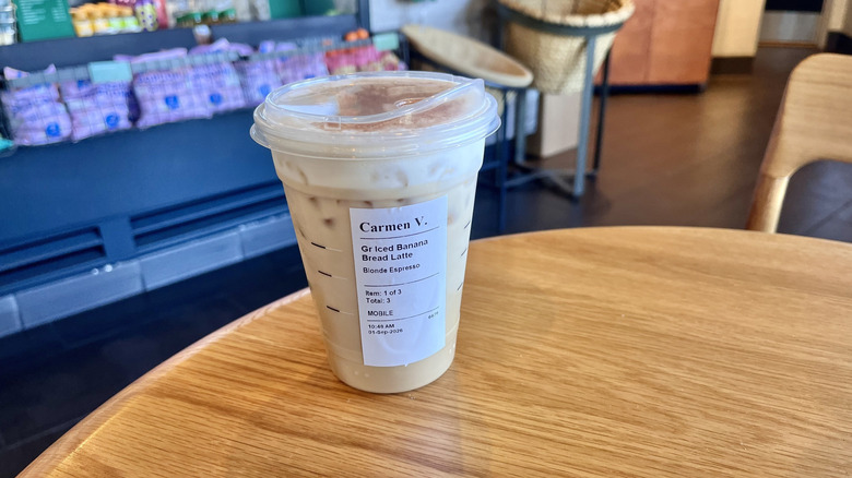 Starbucks Iced Banana Bread Latte on a table inside a coffee shop