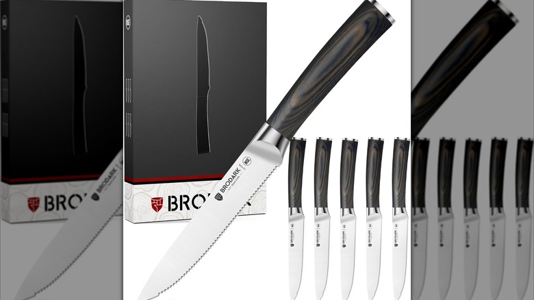 A BRODARK steak knife shown diagonally on a plain background with smaller upright knives and the box