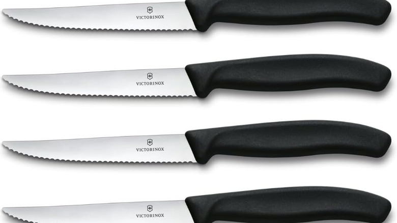 A product shot of four Victorinox steak knives shown on a plain white background