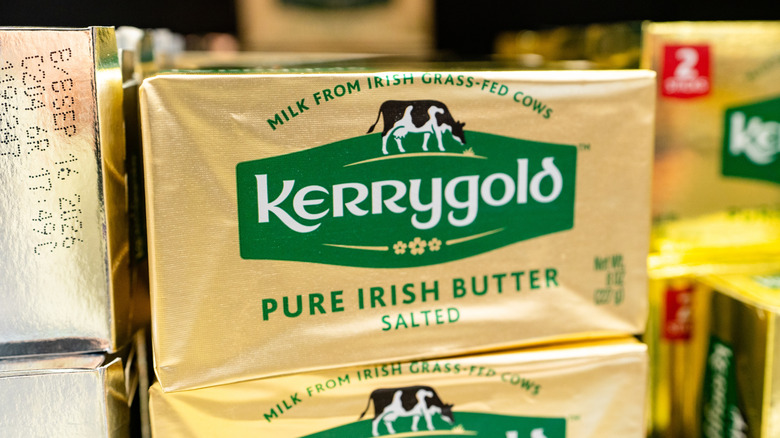 Several foil-wrapped Kerrygold butter packages lining shelf