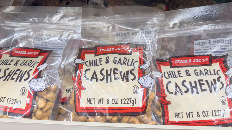 Three packages of chile and garlic cashews on Trader Joe's shelf