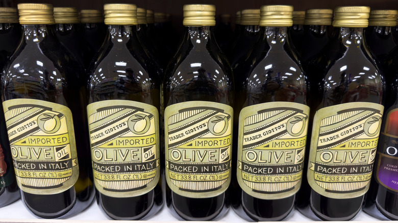 Several bottles of olive oil imported from Italy on shelf