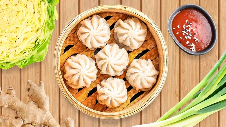 Soup dumplings with cabbage, ginger, and dipping sauce