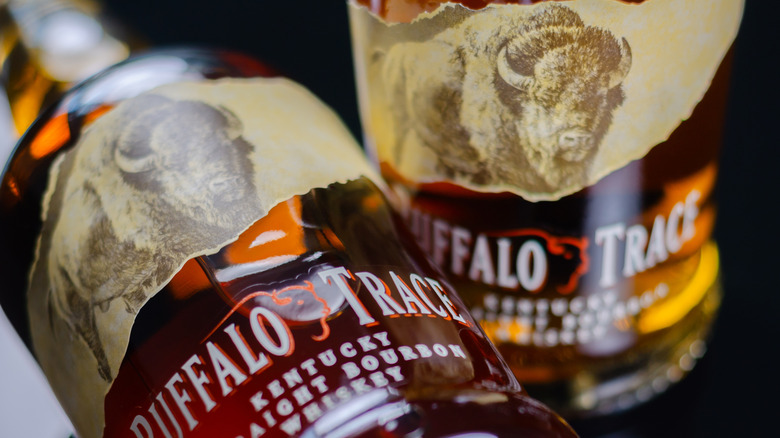 A close up shot of two bottle of Buffalo Trace, with one of them laid on its side