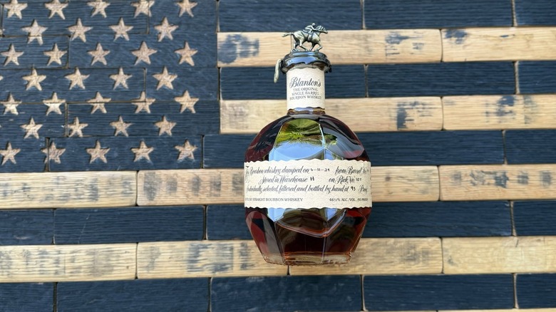 An overhead shot of a bottle of Blanton's laid on a stylized American flag