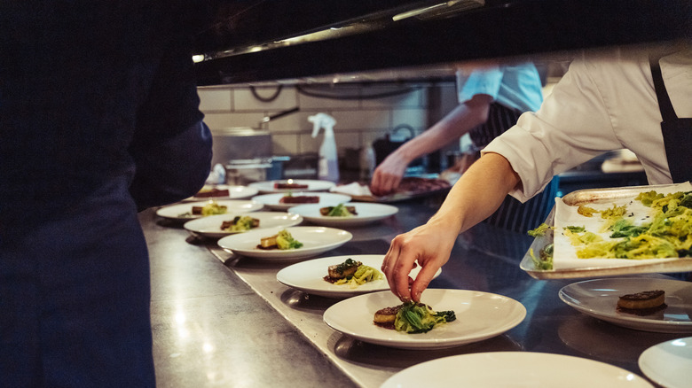 person plating food at a michelin restaurant