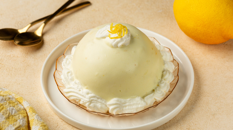 A plate with a single dome of Italian lemon delight dessert