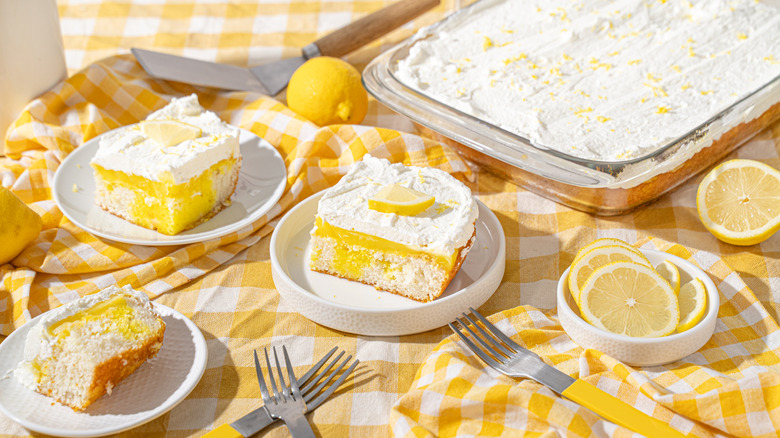 A tray bake of frosted lemon cake with individual servings served in plates