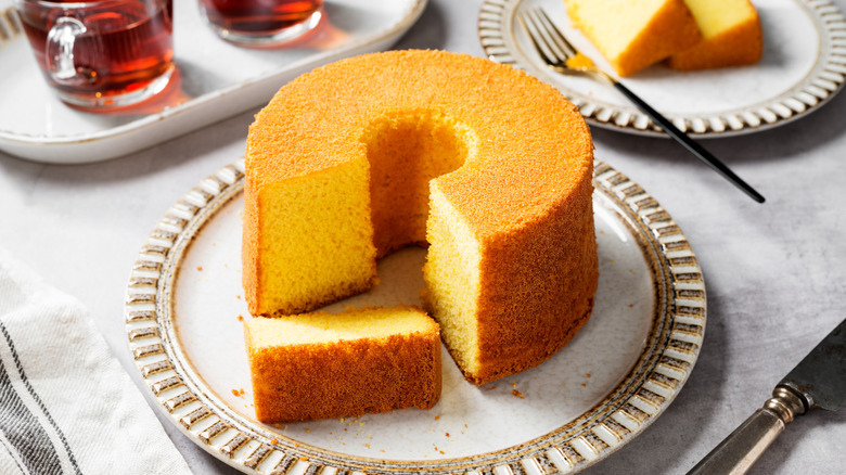 A baked chiffon cake with a slice cut out of it