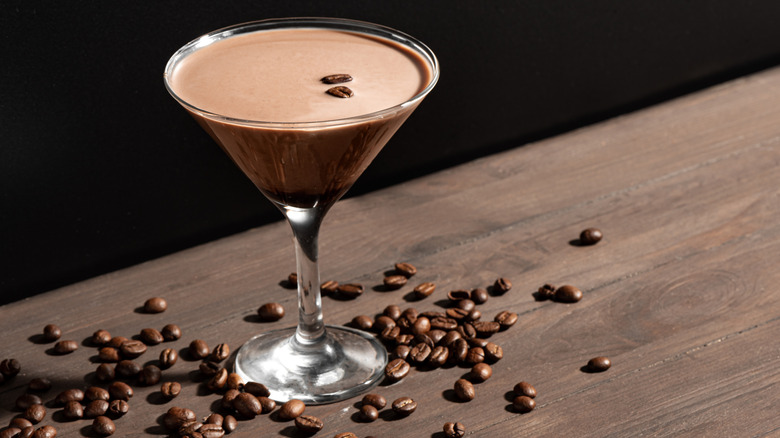 espresso martini with espresso beans on table