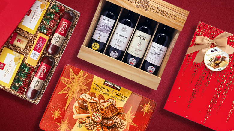 Various holiday gift boxes from Costco containing sausage, crackers, and cheese, wine, cookies, and chocolate
