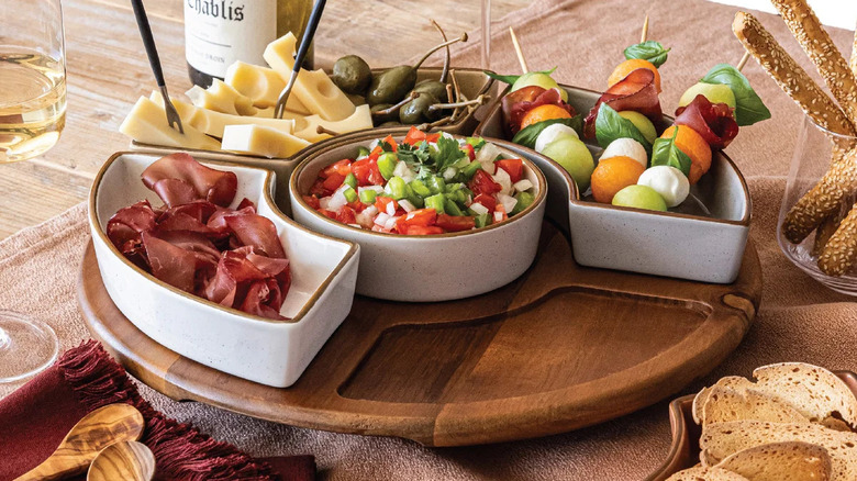 Over&back Options Lazy Susan food serving set with dishes full of cheese, meat, and vegetables