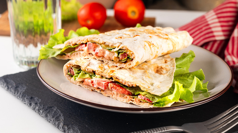 Meat quesadillas on plate with tomatoes and lettuce