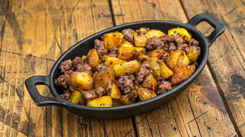 Potato and beef breakfast hash in black baking dish