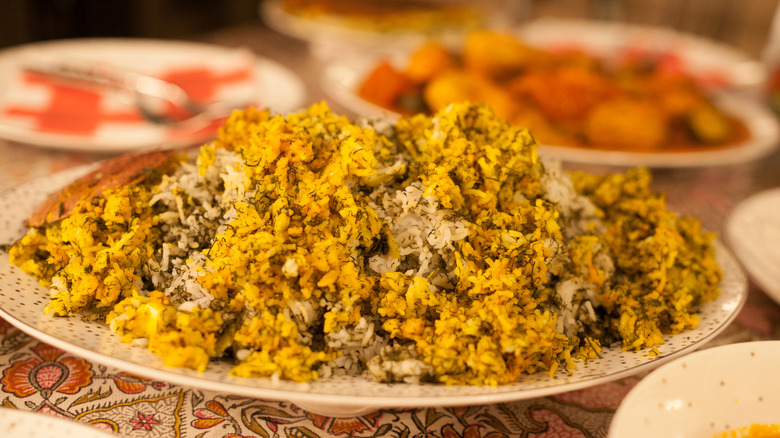 A plate heaped with baghali polo, a persian rice and dill dish