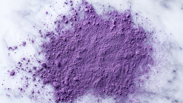 A spatter of ube powder on a marble surface