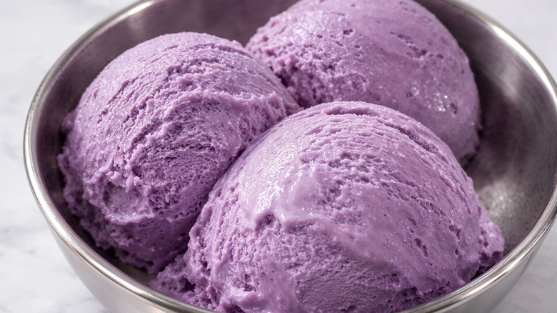 Closeup of a bowl of ube ice cream scoops