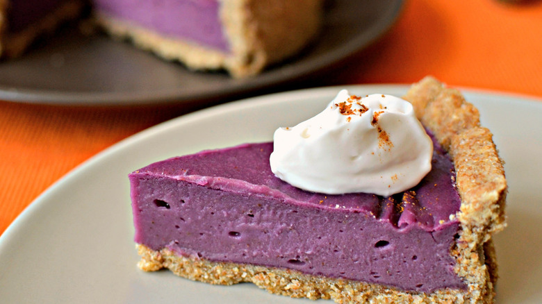 An ube sweet potato pie with a whipped cream topping