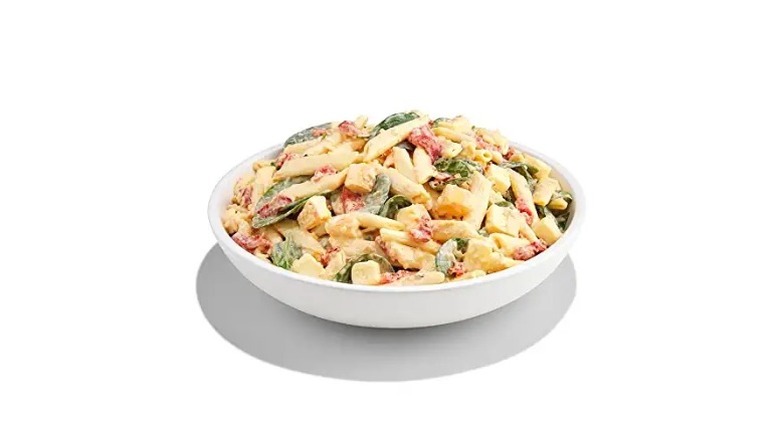 Whole Foods Market mozzarella pasta salad in a white dish on a white background.