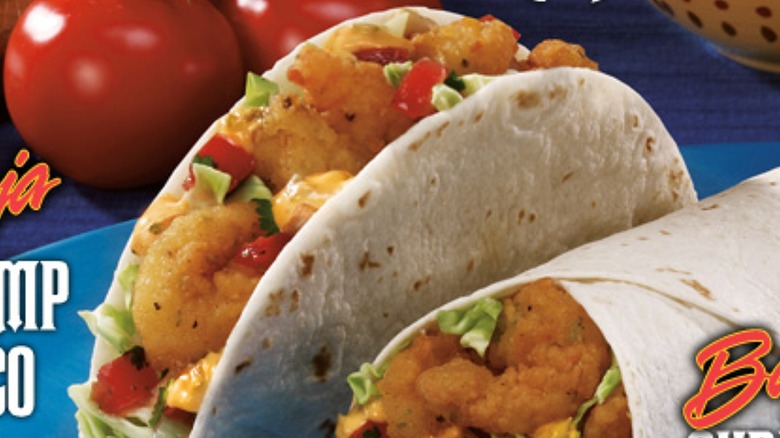 Baja shrimp taco with a burrito and blue background