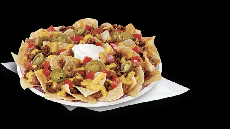 Del Taco Macho Nachos against a black wall