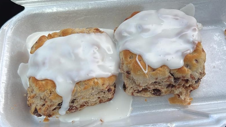 Two Hardee's cinnamon 'n raisin biscuits in a syrofoam container