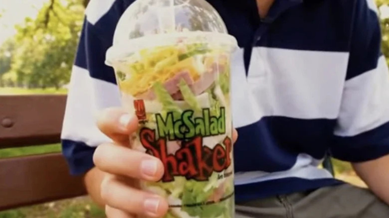 Still from commercial with a hand holding a McSalad Shaker