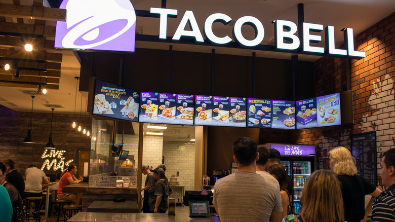 Inside Taco Bell with customers looking at menu