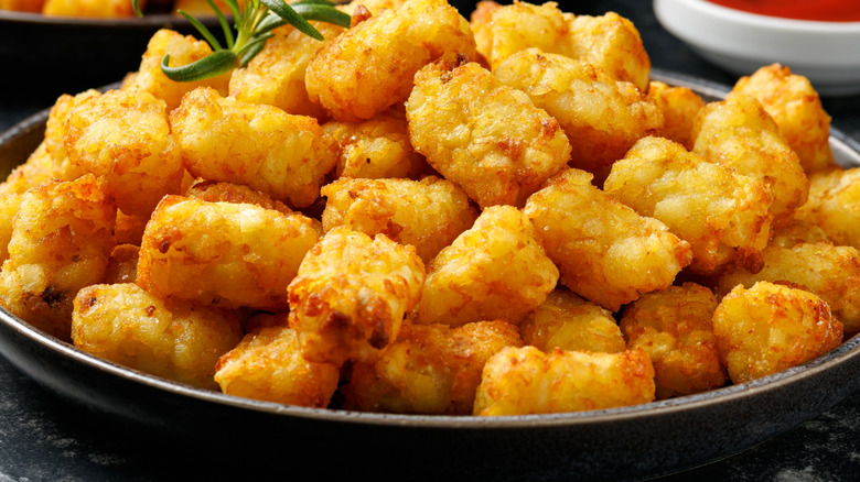 A pile of crispy tater tots in a bowl