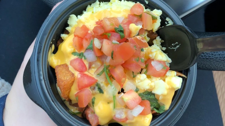 Hand holding mini skillet bowl with spoon