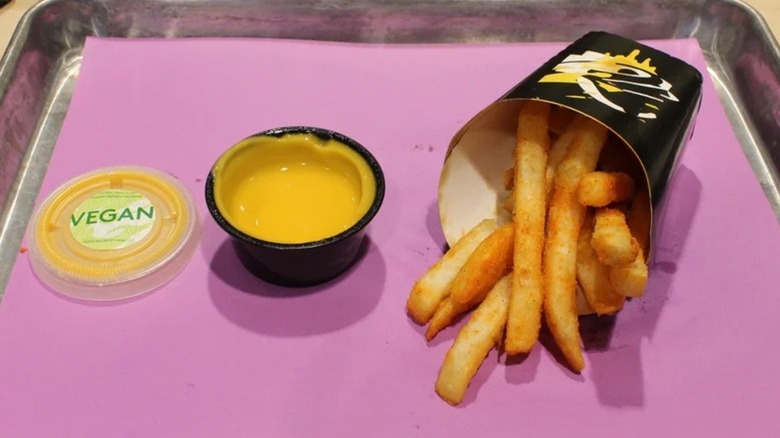 Vegan nacho cheese sauce on a tray with nacho fries