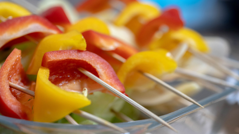 Closeup of skewers with multi colored peppers