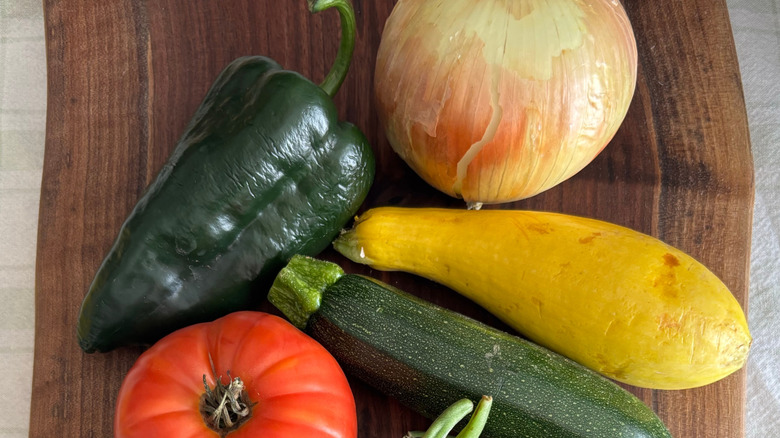 Cutting board filled with vegetables for grilling