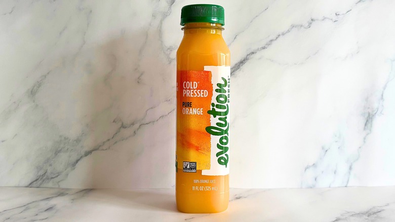 Evolution Fresh Pure Orange juice on marble background