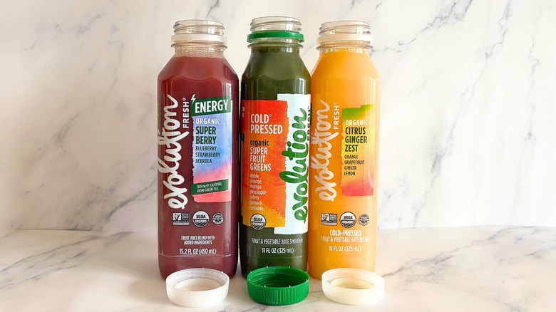 Three Evolution Fresh juices on marble background
