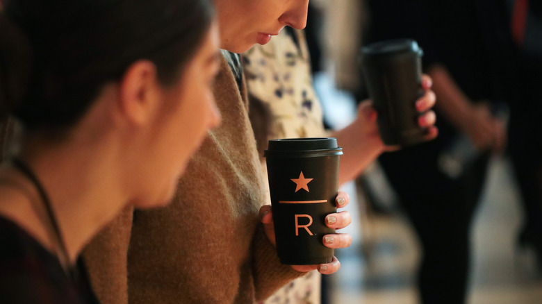 woman holding starbucks reserve cup