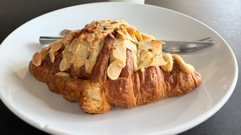 Almond croissant on a white plate from Starbucks